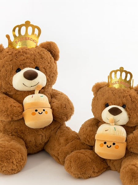 Brown teddy bear wearing crown playing birthday music