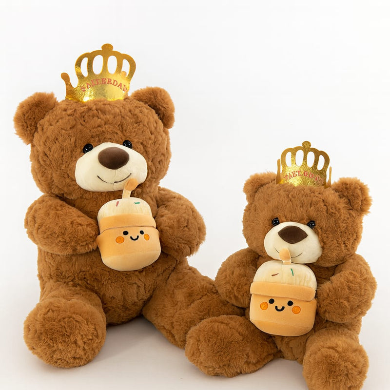 Brown teddy bear wearing crown playing birthday music