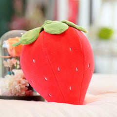 “Small strawberry cushion with green leaf top”