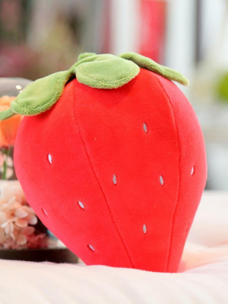 “Small strawberry cushion with green leaf top”