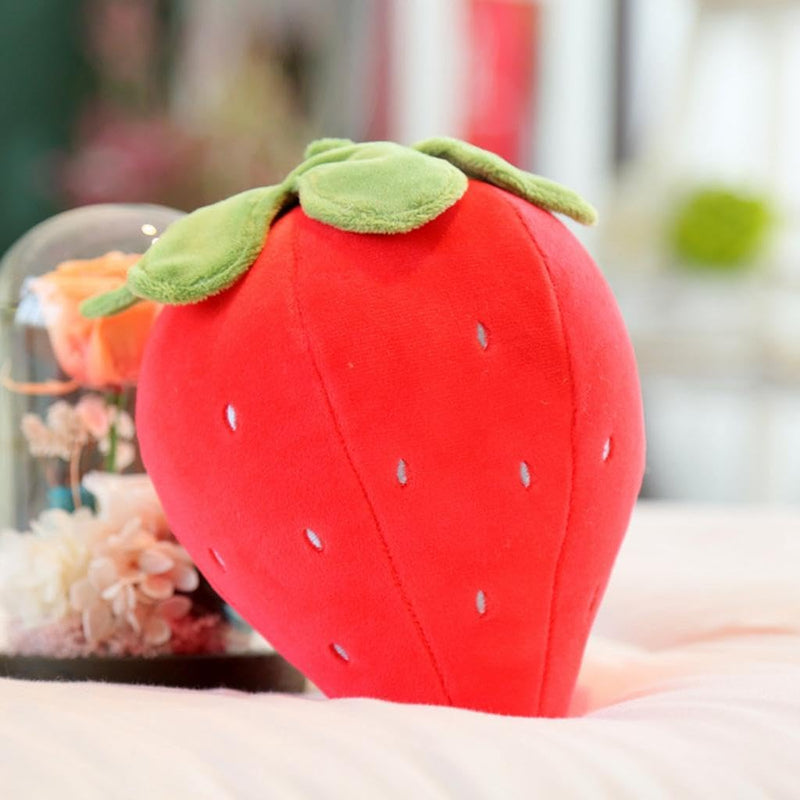 “Small strawberry cushion with green leaf top”
