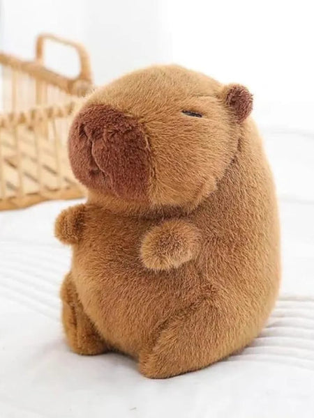Capybara plush sitting on bed