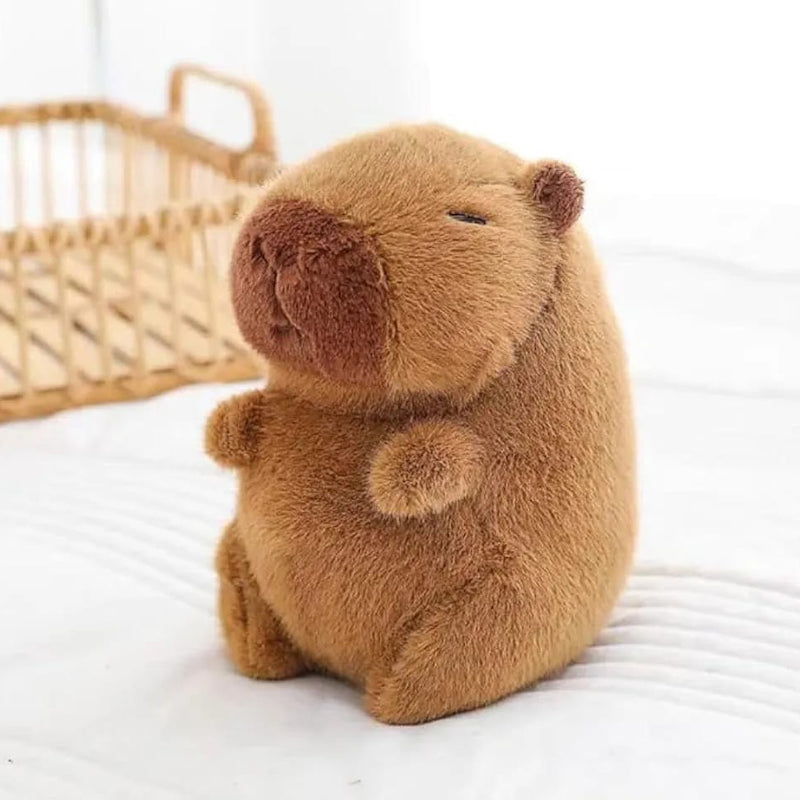 Capybara plush sitting on bed