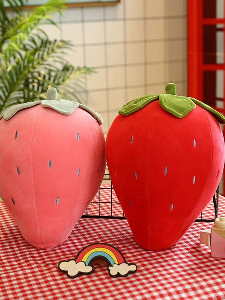 “Small strawberry cushion with green leaf top”